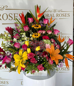 Exotic Tropical Arrangement. Featuring vibrant, exotic flowers in a beautiful arrangement, this piece is sure to bring joy and color to any room, Doral Roses florist, home delivery in Miami