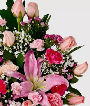 Pretty Pink, New Baby Flowers, Home Delivery in Miami, Pretty Pink, floral arrangement features a stunning mix of pink lilies, roses, and carnations on a rustic wooden base, Doral Roses Miami, home delivery flowers in Miami