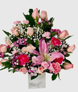 Pretty Pink, New Baby Flowers, Home Delivery in Miami, Pretty Pink, floral arrangement features a stunning mix of pink lilies, roses, and carnations on a rustic wooden base, Doral Roses Miami, home delivery flowers in Miami